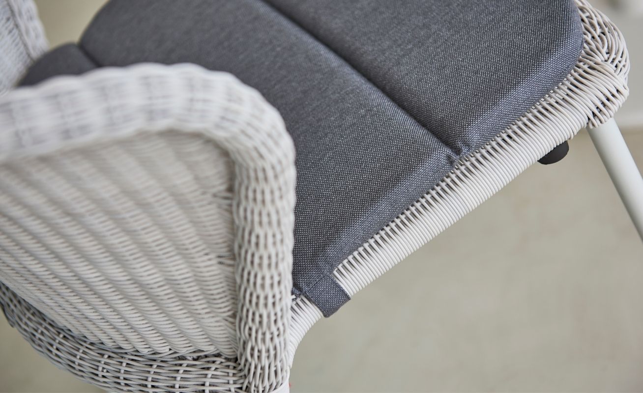 Close up of Lean Outdoor Dining Chair in White Grey Cane-Line Weave with a Dark Grey Cushion - Danish Design Co Singapore
