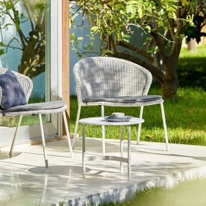 A Pair of Lean Outdoor Lounge Chair in White Grey Cane-Line Weave, in an outdoor setting - Danish Design Co Singapore