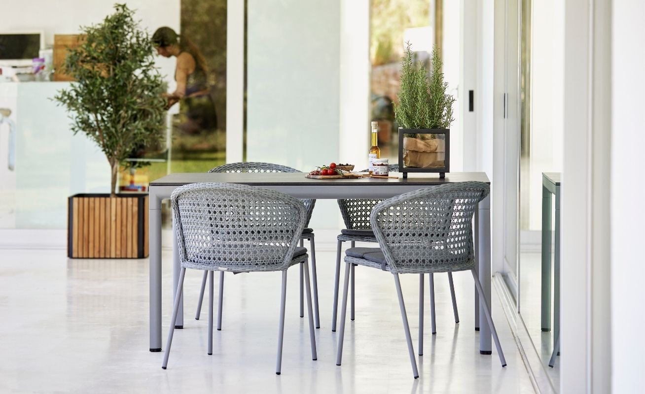 Lean Outdoor Dining Chair in White Grey Cane-Line Weave around a table - Danish Design Co Singapore