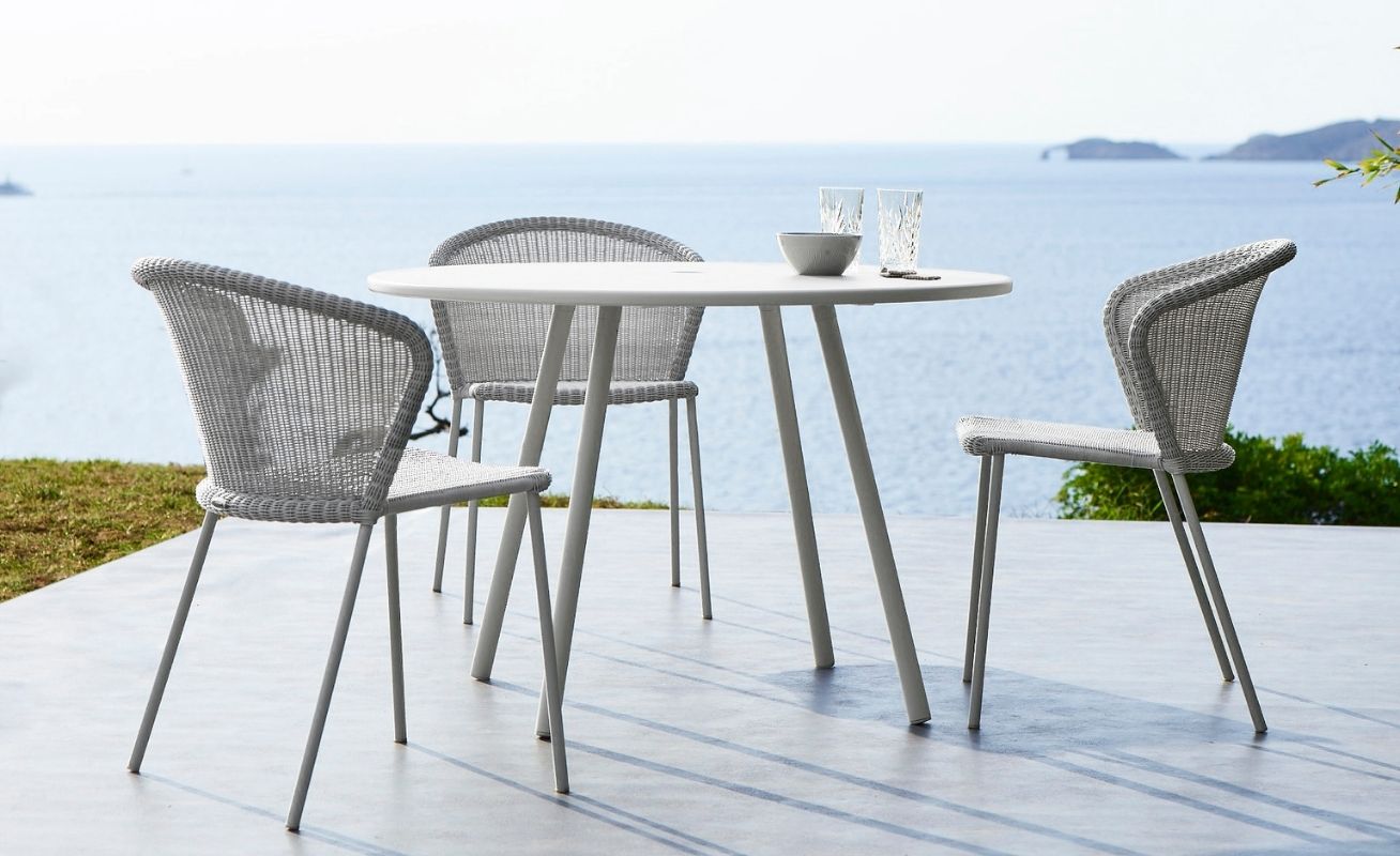 Lean Outdoor Dining Chair in White Grey Cane-Line Weave around a table Danish Design Co Singapore