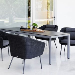 Cane-line Mega Outdoor Dining Chair in Dark Grey with Light Grey Cushions around a grey table - Danish Design Co Singapore