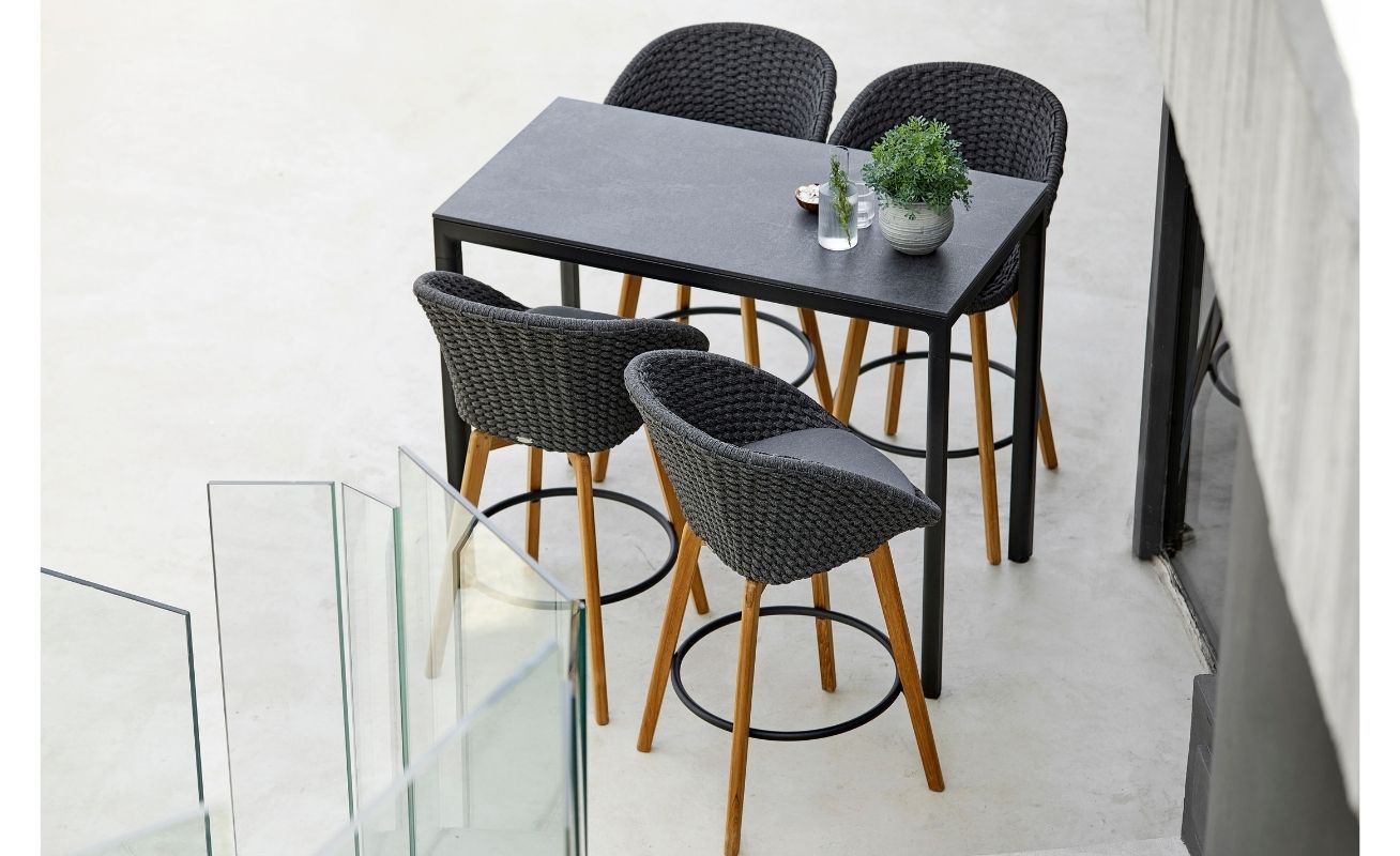 Cane-line Peacock Outdoor Bar Chair in dark grey with a light cushion - Danish Design Co Singapore