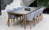 Cane-line Peacock Outdoor Dining Chair Light grey seat with light grey cushion and teak legs on patio - Danish Design Co Singapore