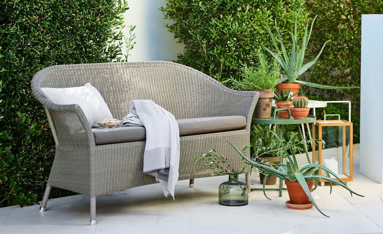 Lansing 3 seater outdoor sofa in taupe cane and taupe cushions in an outdoor setting - Danish Design Co Singapore